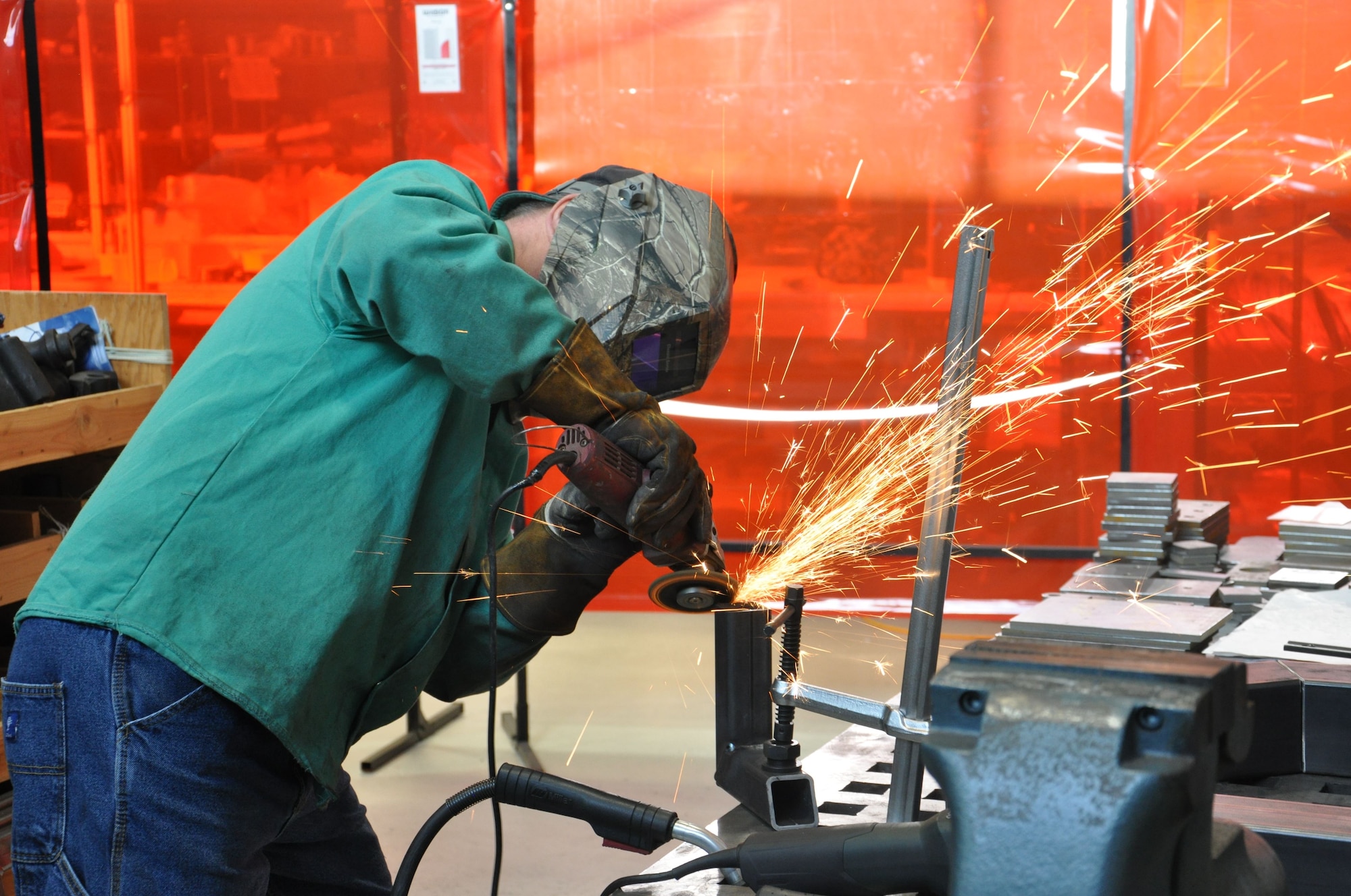 Tom Nartker, Welder & Fabricator is grinding a part for the AC-130J Sensor Special Test Equipment (U.S. Air Force photo/W. Eugene Barnett)