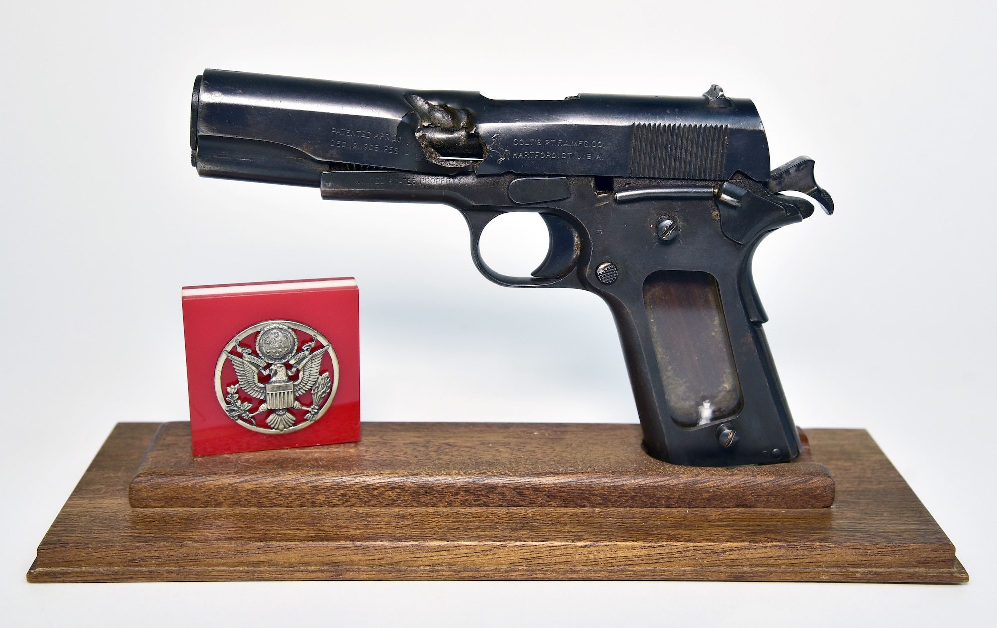 Plans call for this artifact to be displayed near the B-17F Memphis Belle™ as part of the new strategic bombardment exhibit in the WWII Gallery, which opens to the public on May 17, 2018. Flak-damaged M1911 .45-cal pistol and cap badge worn by Sgt Roy Zeran, 97th Bomb Group, when his B-17 was shot down on November 20, 1942. (The cap badge is post-World War II).