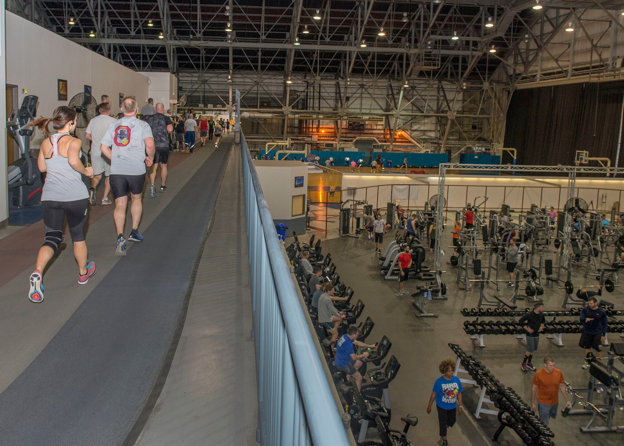 Members of Wright-Patterson Air Force Base exercise inside Wright Field Fitness Center at Wright-Patterson Air Force Base, Ohio, Jan. 25, 2017. The Fitness Center operated by the 88th Force Support Squadron offers an indoor running track, aerobics, indoor cycling, yoga, equipment instruction, kickboxing, and special services such as massage therapy and personal fitness trainers. (U.S. Air Force photo by Michelle Gigante/Released)