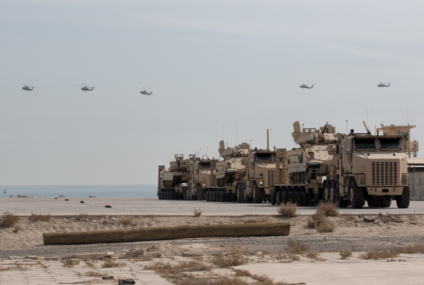 Black Hawks Fly Over Armored Vehicles