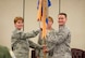 Col. Cherie Roff, 315th Mission Support Squadron commander, passes the 38th Aerial Port Squadron guide on to Maj. Jason Scnyder, new 38th APS commander, during a 315th MSG double assumption of command ceremony Feb. 11 at Joint Base Charleston, S.C. Snyder previously served as the 38th APS operations officer. (U.S. Air Force photo by 1st Lt. Rashard Coaxum)