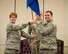 Col. Cherie Roff, 315th Mission Support Squadron commander, passes the 315th Logistics Readiness Squadron guide on to Maj. Franklin Rinaca, new 315th LRS commander, during a 315th MSG double assumption of command ceremony Feb. 11 at Joint Base Charleston, S.C. Rinaca previously served as the 315th LRS operations officer. (U.S. Air Force photo by 1st Lt. Rashard Coaxum)