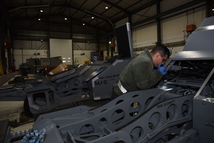 Airman 1st Class Andrei Perez, 48th Equipment Maintenance Squadron bomb lift maintainer, performs maintenance on a bomb lift at Royal Air Force Lakenheath, England, Feb. 7. AGE Airmen maintain flightline equipment such as generators, flood lights and bomb lifts. (U.S. Air Force photo/Senior Airman Abby L. Finkel)