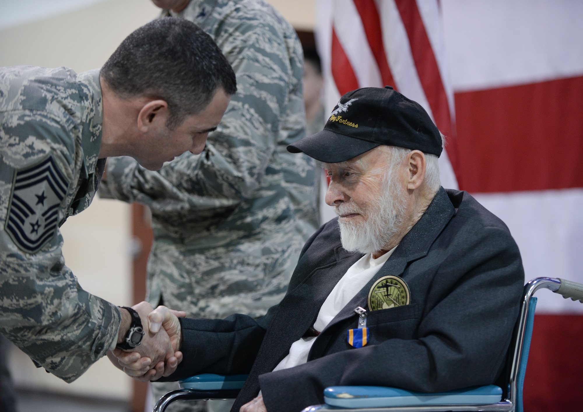 Chief Master Sgt. Brian Kruzelnick, 55th Wing command chief, thanks Gail Farrell, a 93-year old World War II and Korean War veteran who flew 21 missions as a tail gunner in the B-17 Flying Fortress, for his service after a medal presentation ceremony at the James M. McCoy Airman Leadership School Feb. 8, 2018. Col. Mike Manion, 55th Wing commander, presented Farrell with an Air Medal with two oak leaf clusters; the European-African Middle Eastern Campaign Medal with three bronze service stars; the American Campaign Medal; the World War II Victory Medal; and the Honorable Service Lapel Button, WWII.