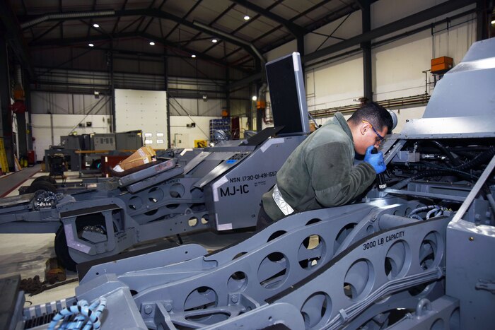 An airman works on a piece of equipment.