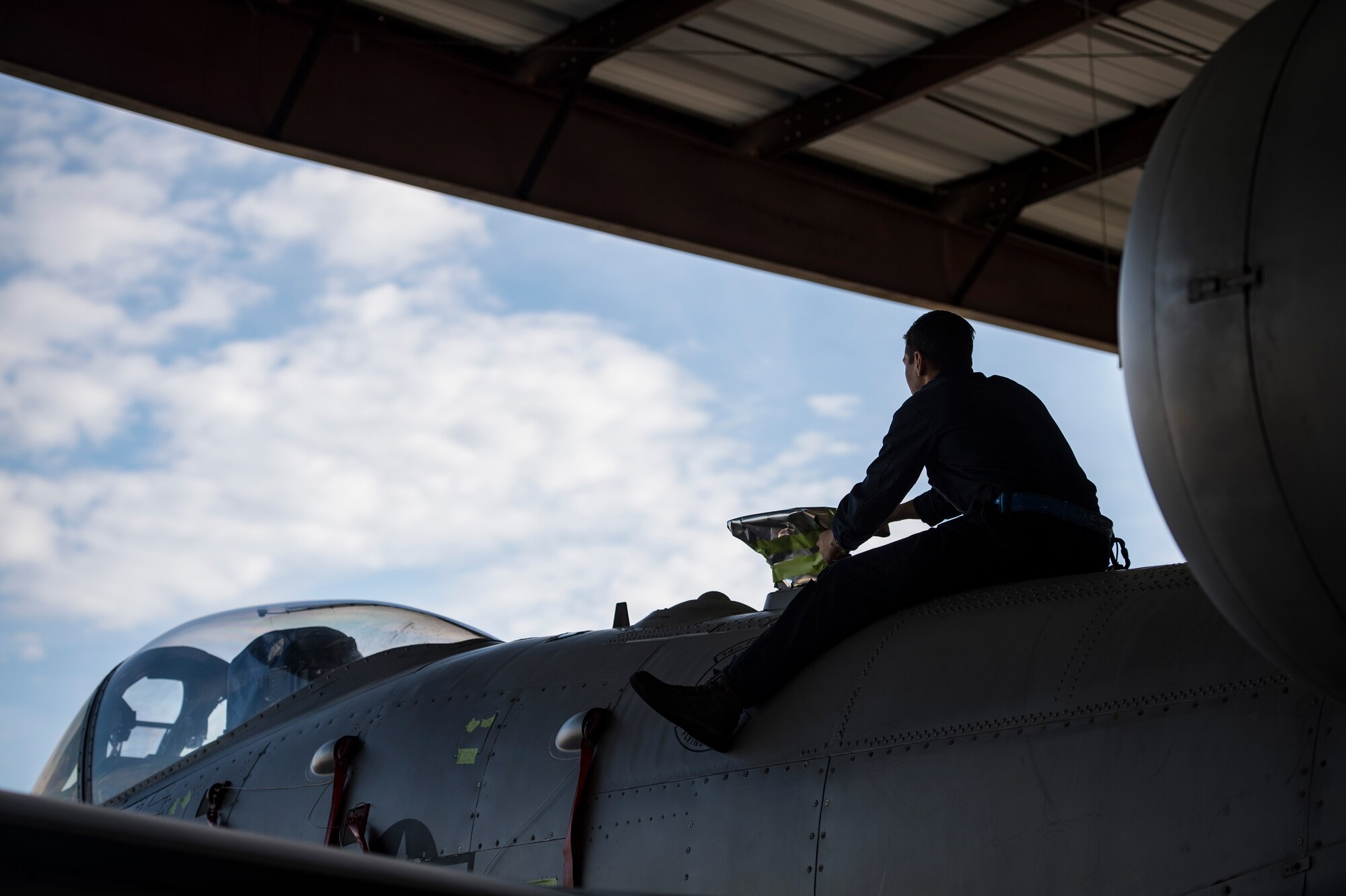 Senior Airman Michael Atkinson, 74th Aircraft Maintenance Unit dedicated crew chief, protects a component before washing an A-10C Thunderbolt II, Feb. 8, 2018, at Moody Air Force Base, Ga. Airmen sealed off various electrical components prior to the wash to protect them from chemicals within the soap. In addition to mechanical and electrical maintenance, A-10’s must be washed every 180 days or approximately 1,000 flying hours in order to control corrosion caused by residue from the gun and engine exhaust. (U.S. Air Force photo by Senior Airman Janiqua P. Robinson)