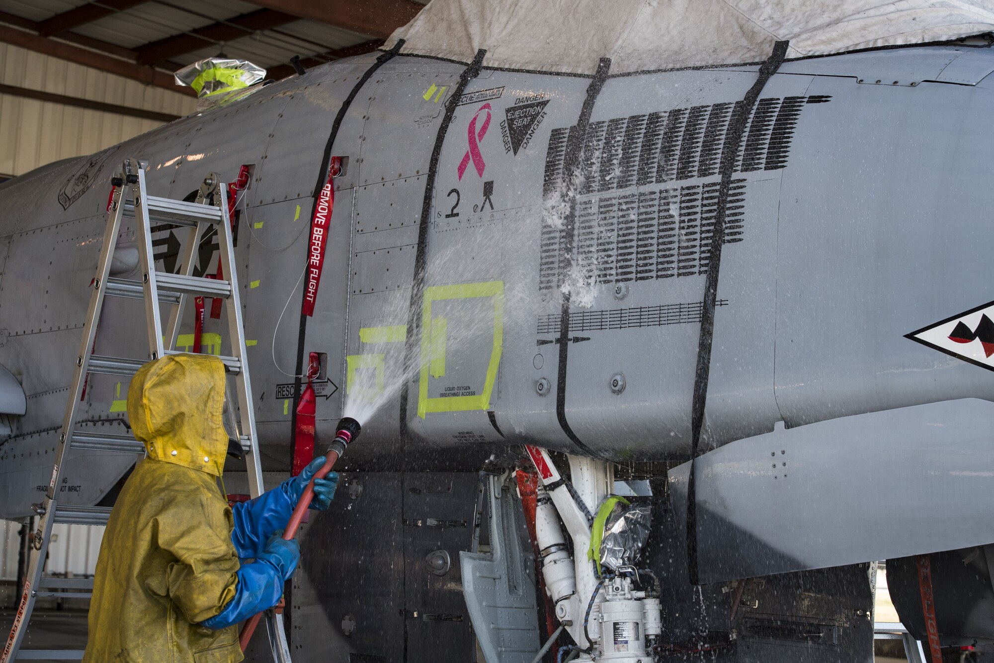Senior Airman Michael Atkinson, 74th Aircraft Maintenance Unit dedicated crew chief, sprays the side of an A-10C Thunderbolt II, Feb. 8, 2018, at Moody Air Force Base, Ga. In addition to mechanical and electrical maintenance, A-10’s must be washed every 180 days or approximately 1,000 flying hours in order to control corrosion caused by residue from the gun and engine exhaust. (U.S. Air Force photo by Senior Airman Janiqua P. Robinson)