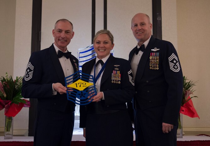 Chief Master Sgt. Larry C. Williams, U.S. Air Force Expeditionary Center command chief, left, recognizes Senior Master Stephanie Northup, 43rd Operations Support Squadron superintendent, center, along with Chief Master Sgt. Todd Cole, 628th Air Base Wing command chief, right, during the chief master sergeant recognition ceremony at the Charleston Club Feb. 10, 2018.