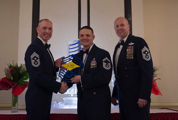 Chief Master Sgt. Larry C. Williams, U.S. Air Force Expeditionary Center command chief, left, recognizes Senior Master Sgt. Michael Stone, 437th Aircraft Maintenance Squadron superintendent, center, along with Chief Master Sgt. Todd Cole, 628th Air Base Wing command chief, right, during the chief master sergeant recognition ceremony at the Charleston Club Feb. 10, 2018.
