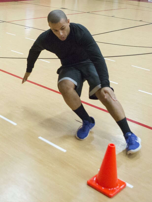 Sgt. James Toney, security specialist, U.S. Marine Corps Forces Command, runs the "5-10-5" shuttle run during a High Intensity Tactical Training Level II instructor course at Hopkins Hall Gym aboard Camp Allen, Va., Feb. 12. Marines had to demonstrate their abilities to instruct a HITT class, which included setting up drill stations, conducting functional assessments, and instructing other Marines on movement drills while maintaining safety standards. (Official U.S. Marine Corps photo by Chris Jones/Released)