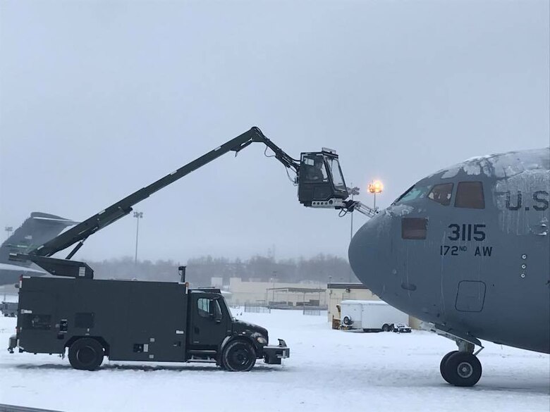 Airmen assigned to the 821st Contingency Response Group deice a C-17 Globemaster aircraft during the Rapid Alaskan Airlift Week exercise at Eielson Air Force Base, Alaska, Jan. 19 through 26. The week-long exercise is designed to optimize exercise opportunities in a cold weather environment for mobility Airmen and allow for sharing of tactics, techniques and procedures across the Joint Force. (Courtesy photo)