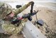 Airmen reloading machine gun