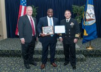 PANAMA CITY, Florida - Dr. Jermaine Kennedy, center, receives the 2017 Outstanding Innovation Award at Naval Surface Warfare Center Panama City Division's (NSWC PCD) 2017 Annual Awards ceremony Jan. 12, 2018. U.S. Navy photo by Eddie Green