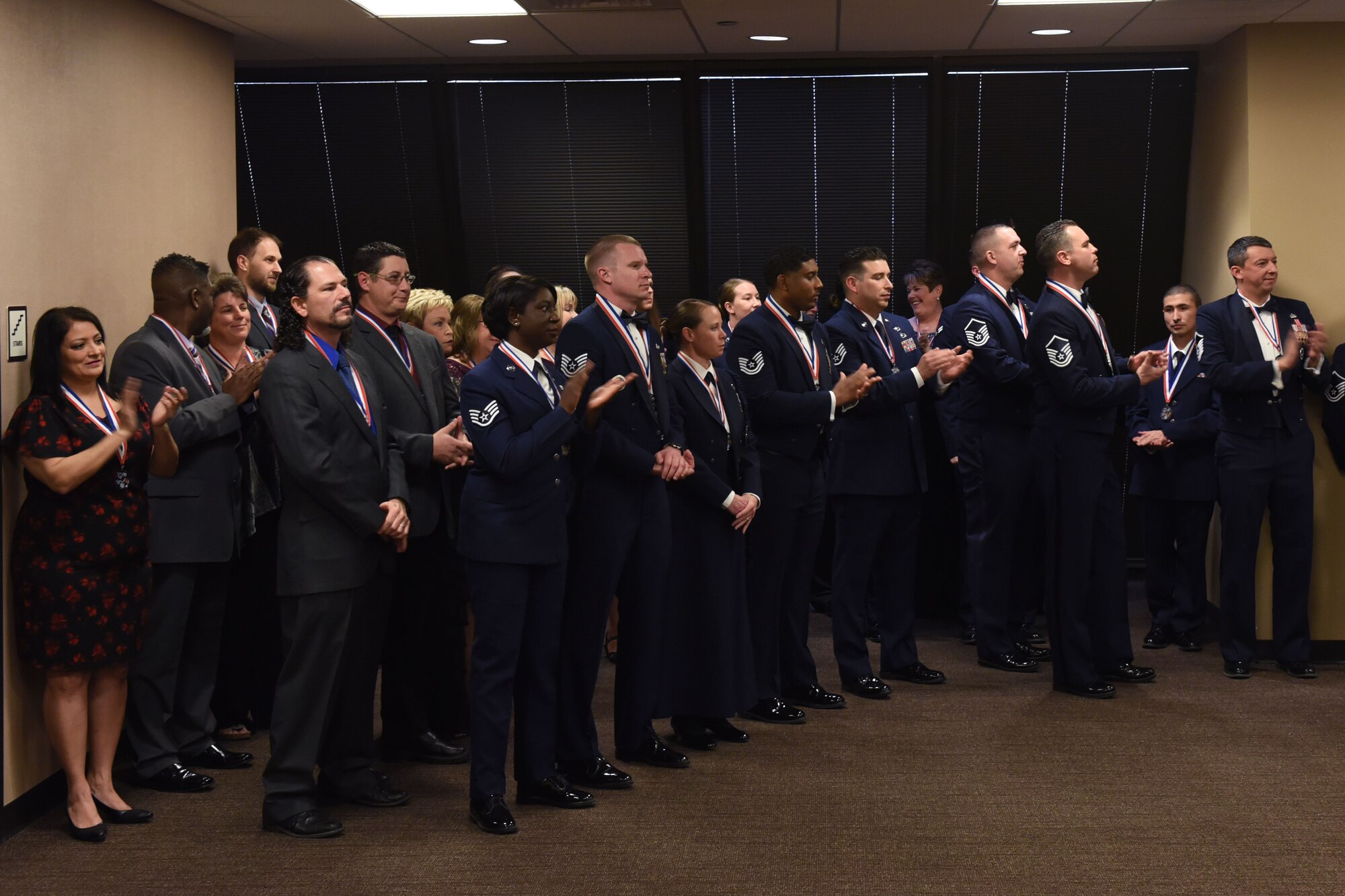 Annual Award nominees celebrate during the 25th Annual Awards Ceremony at the McNeese Convention Center in San Angelo, Texas, Feb. 9, 2018. Each nominee received a medallion as recognition for their nomination. (U.S. Air Force photo by Airman 1st Class Zachary Chapman)