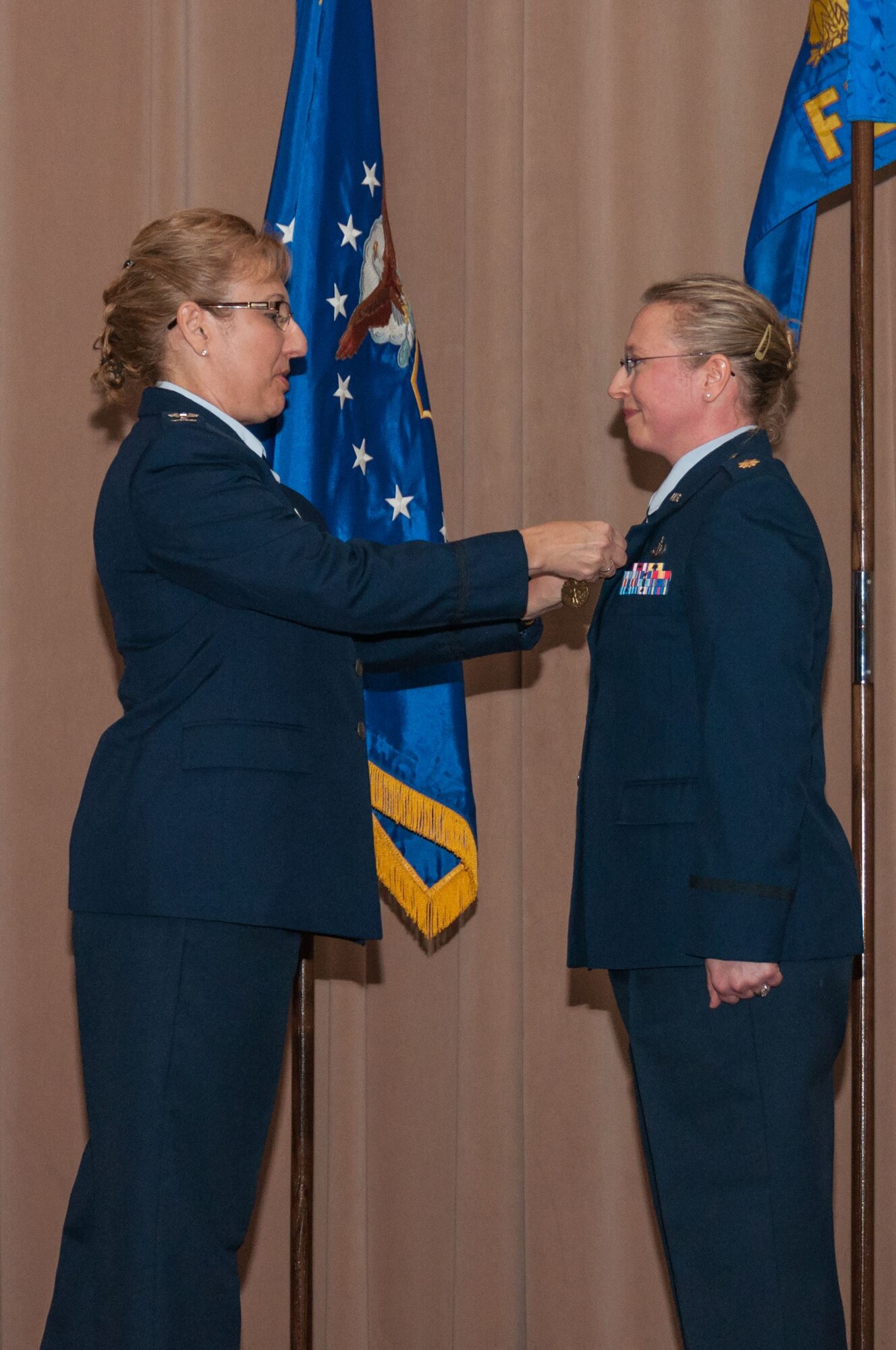 U.S. Air Force Col. Sandra Vandiviere, 307th Mission Support Group commander, pins the Meritorious Service Medal, third oak leaf cluster, on Maj. Beth Hart, 307th Force Support Squadron commander, during the change of command ceremony at Barksdale Air Force Base, Louisiana, Feb. 10, 2018.