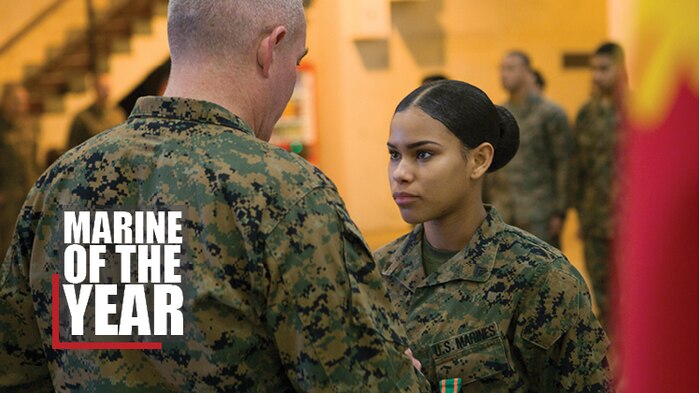 Brig. Gen. Daniel B. Conley, left, commanding general, 3rd Marine Logistics Group, presents Cpl. Nelfi Tineoferreiras, the noncommissioned officer-in-charge of Receiving Section, Supply Company, Combat Logistics Regiment 35, 3rd MLG, with the III Marine Expeditionary Force’s Marine of the Year at Camp Kinser, Okinawa, Japan, Feb. 8, 2018. Tineoferreiras was honored as III MEF’s Marine of the Year for being exemplary in her duties, which included her technical proficiency and demonstration of the Marine Corps' core values. Tineoferreiras is a native of the Dominican Republic and was recruited into the Marine Corps from Brooklyn, New York. (U.S. Marine Corps photo by Lance Cpl. Jamin M. Powell)