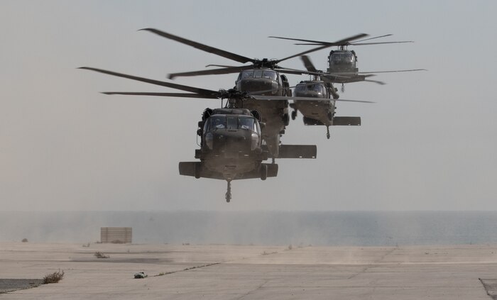 UH-60 Black Hawk helicopters carrying distinguished visitors arrive for Army Day 2018, Feb. 9, 2018, Kuwait Naval Base, Kuwait. Army Day was the opening event for U.S. Central Command’s Component Commanders Conference that allowed U.S. Army Central to showcase the Army’s capabilities at the theater level. (U.S. Army photo by Sgt. 1st Class Ty McNeeley, U.S. ARCENT PAO)