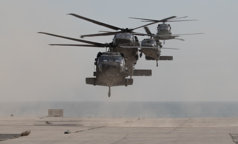 UH-60 Black Hawk helicopters carrying distinguished visitors arrive for Army Day 2018, Feb. 9, 2018, Kuwait Naval Base, Kuwait. Army Day was the opening event for U.S. Central Command’s Component Commanders Conference that allowed U.S. Army Central to showcase the Army’s capabilities at the theater level. (U.S. Army photo by Sgt. 1st Class Ty McNeeley, U.S. ARCENT PAO)