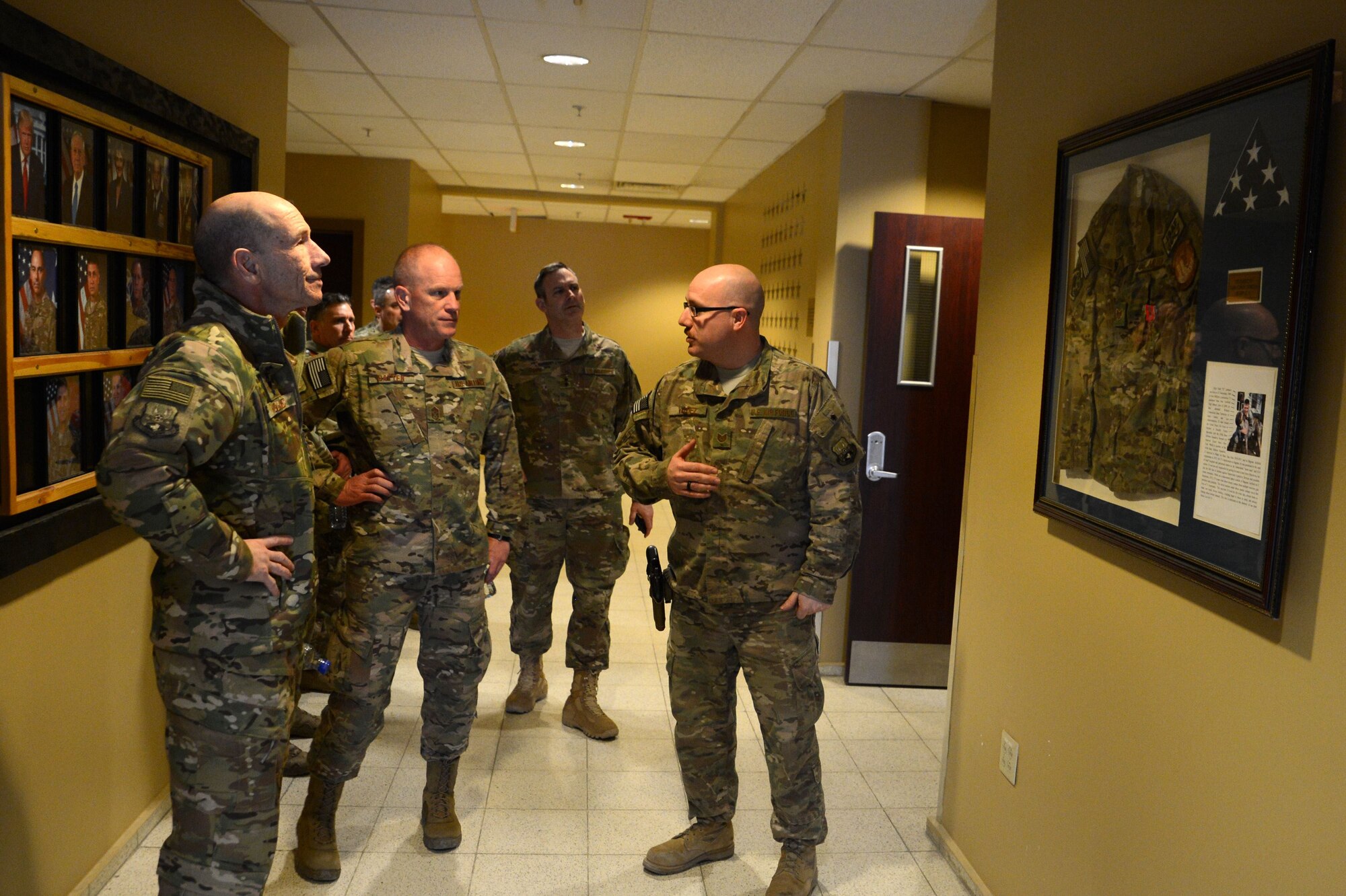 Gen. Mike Holmes, commander of Air Combat Command, and Chief Master Sgt. Frank Batten, ACC command chief, receives a Heritage Room brief from Tech. Sgt. Jose Valdez, 455th Air Expeditionary Wing command and control controller, Feb. 9, 2018 at Bagram Airfield, Afghanistan.