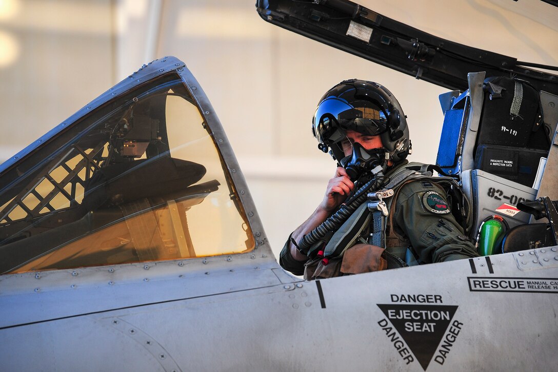 An Air Force pilot secures his oxygen mask before taxiing his A-10C Thunderbolt II.