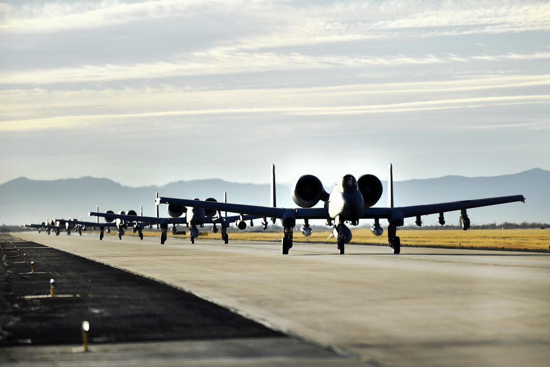 Six Air Force A-10C Thunderbolt IIs taxi down the flight line.