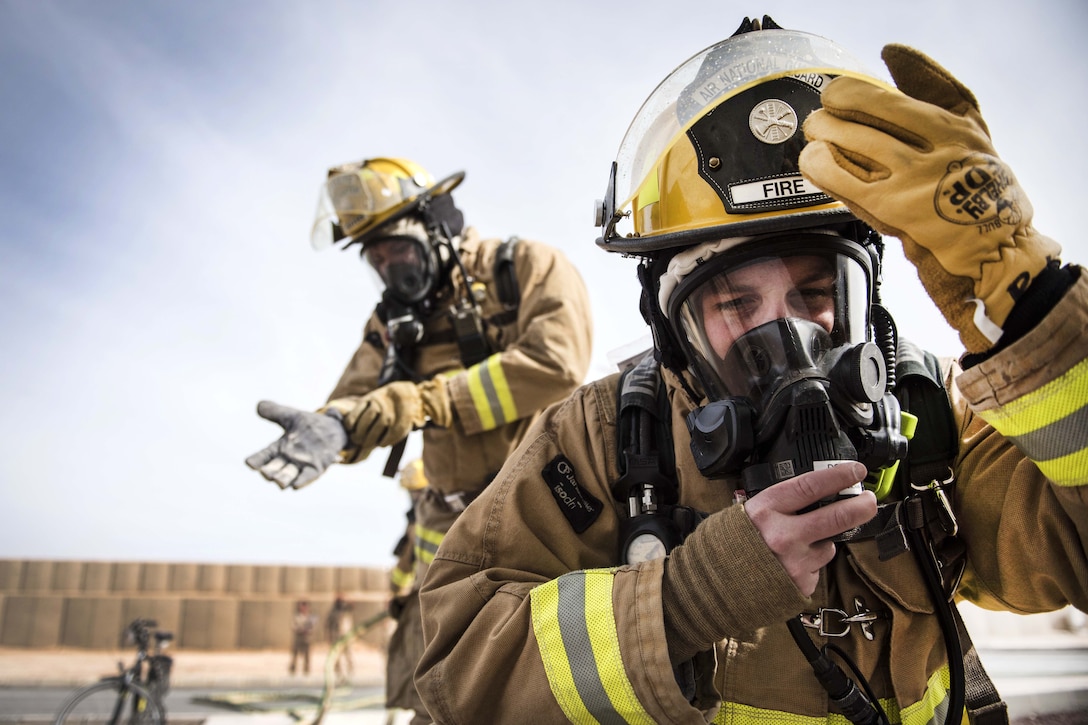 Air Force firefighters respond to a simulated structure fire.