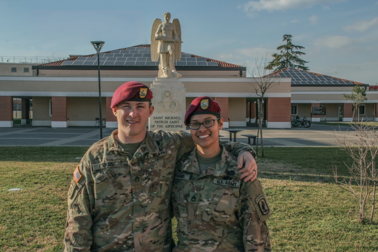 Married airborne soldiers pose in front of the St. Michael statue in Vicenza, Italy.
