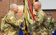 (Left) Maj. Gen. Bruce Hackett, commander of the 80th Training Command, receives the unit's guidon from Command Sgt. Maj. Jeffrey Darlington at the command's change of responsibility ceremony held at the Defense Supply Center Richmond, Virginia, during the 80th TC Commander's Readiness Workshop Feb. 8, 2018.  As the outgoing senior enlisted leader of the 80th TC, Darlington handed over the reins to the incoming senior enlisted leader Command Sgt. Maj. Dennis Thomas. (U.S. Army Reserve Photo by Maj. Addie Leonhardt)