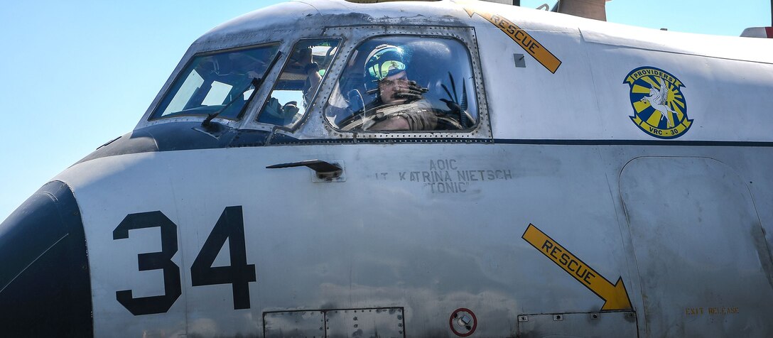 Navy Lt. Brent Burger prepares to take off in a C-2A Greyhound aircraft.