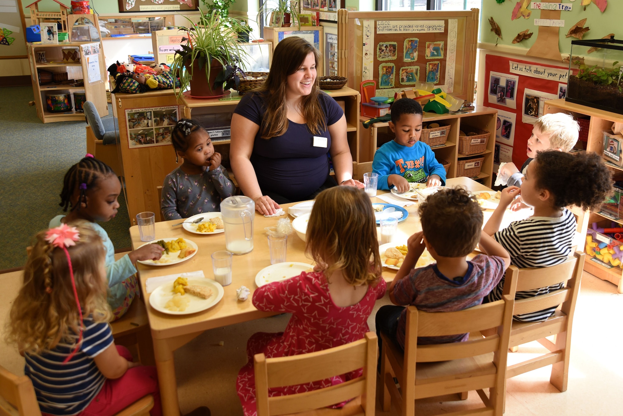 Meredith Yoder, 20th Force Support Squadron (FSS) program assistant, center, converses with children in her class during lunch at the 20th FSS Child Development Center at Shaw Air Force Base, S.C., Feb. 12, 2018.