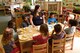Meredith Yoder, 20th Force Support Squadron (FSS) program assistant, center, converses with children in her class during lunch at the 20th FSS Child Development Center at Shaw Air Force Base, S.C., Feb. 12, 2018.