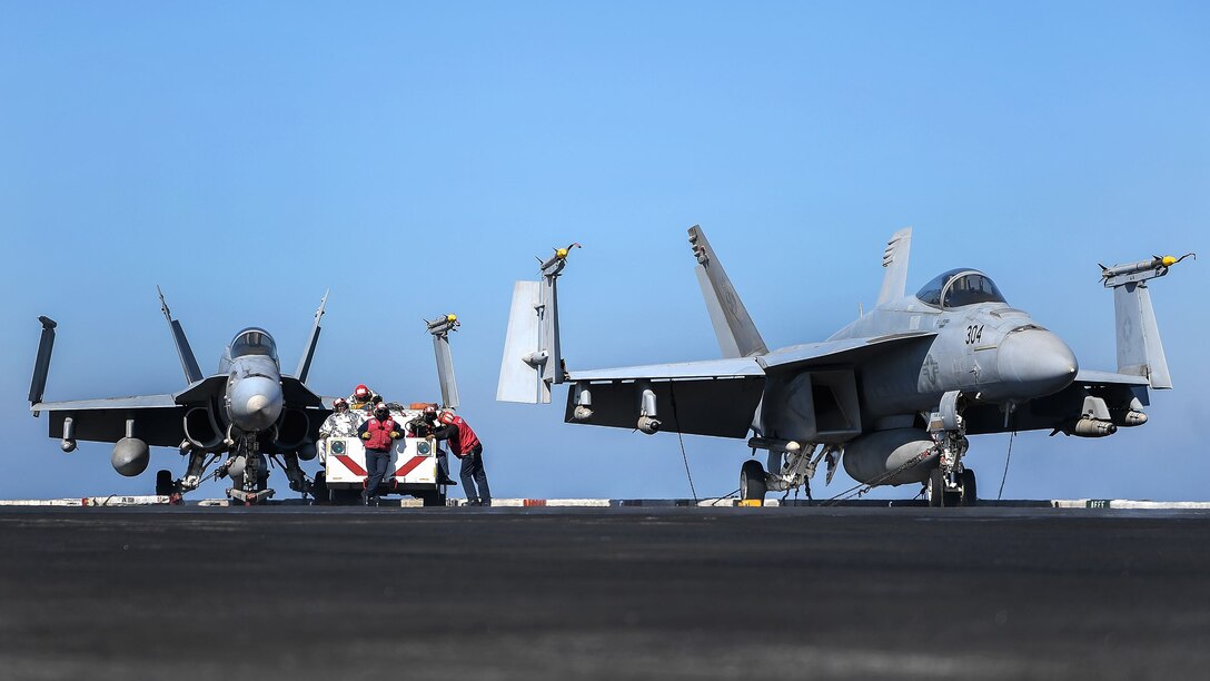Sailors assigned to crash and salvage stand watch during flight operations.