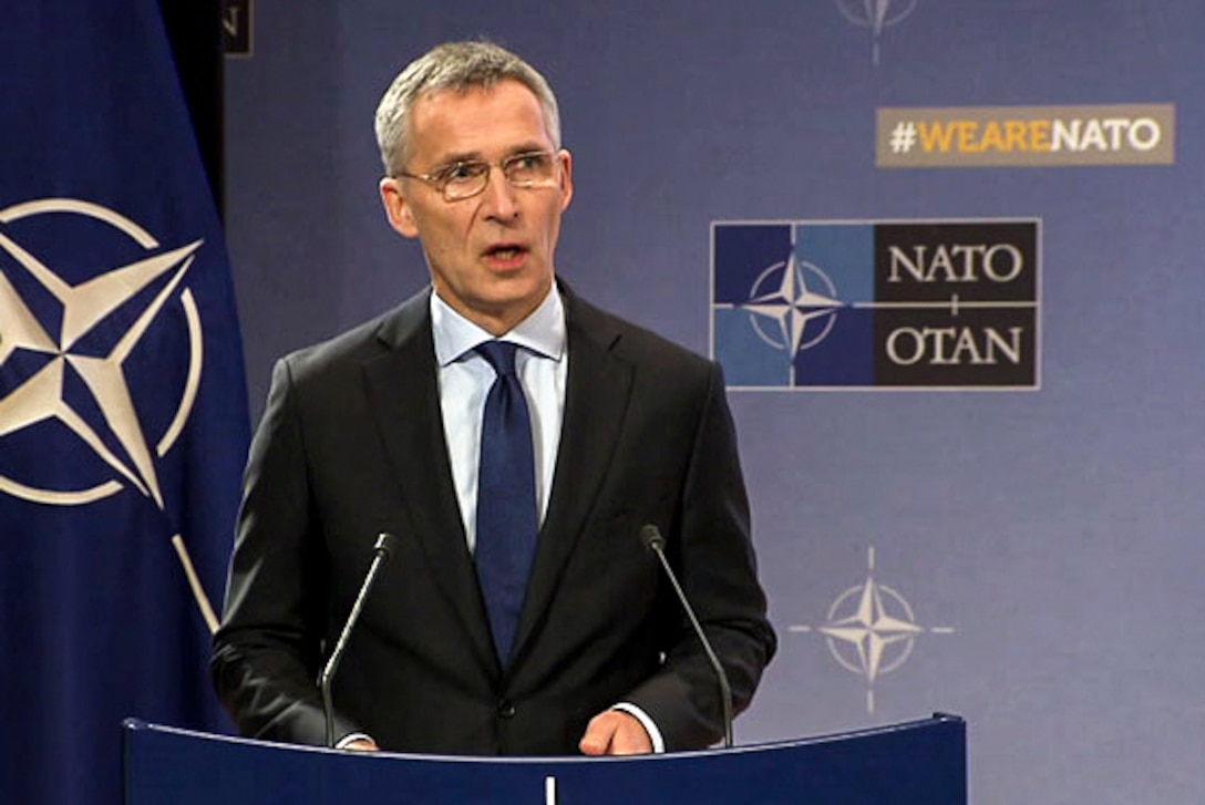 NATO's secretary general stands at a podium as he discusses alliance progress.