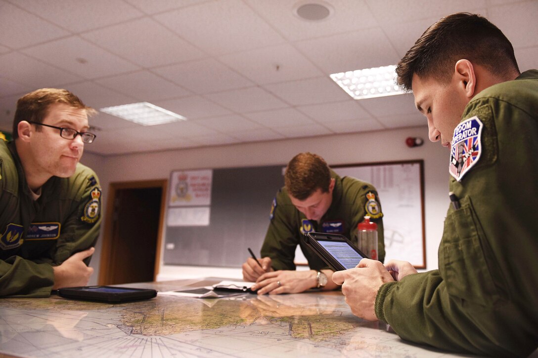Air Force Senior Airman Ryan Hortman, right, gives a mission brief before conducting air refueling training.