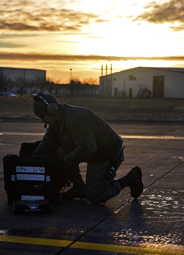 An Air Force airman prepares his equipment before conducting air refueling training.