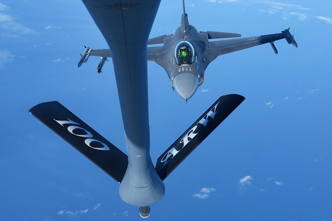 An Air Force F-16C Fighting Falcon flies behind a KC-135 Stratotanker.