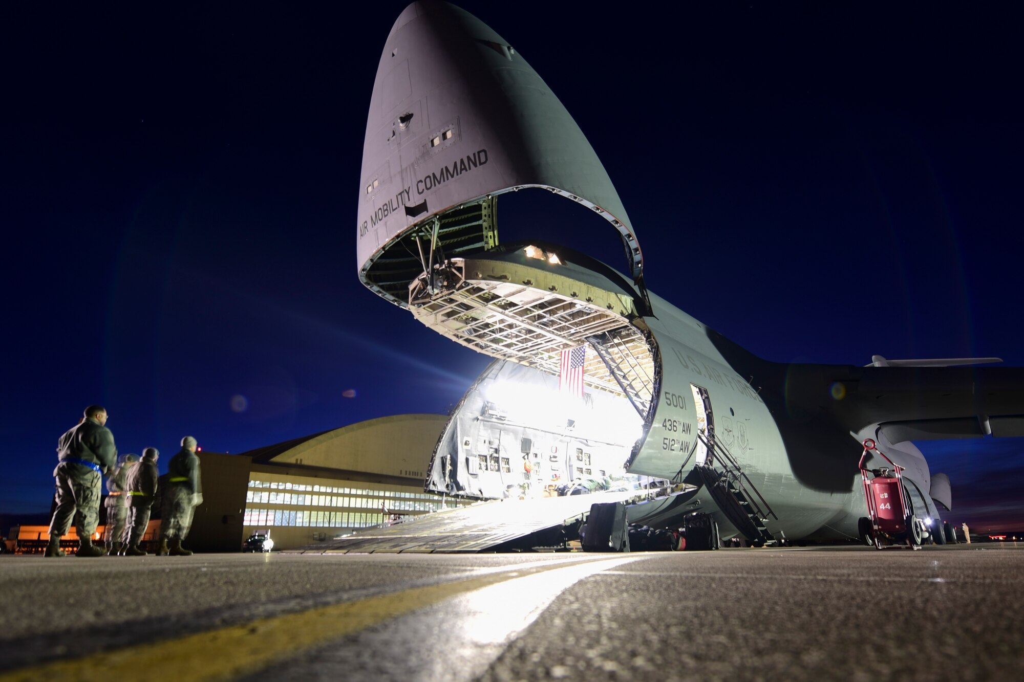 A C-5M Super Galaxy carrying equipment from the recent deployment to Andersen Air Force Base, Guam, is unloaded by 28th Logistics Readiness Squadron Airmen on the flight line at Ellsworth AFB, S.D., Feb. 2, 2018. Multiple aircraft were needed to get all of the cargo back from Andersen AFB. (U.S. Air Force photo by Senior Airman Randahl J. Jenson)