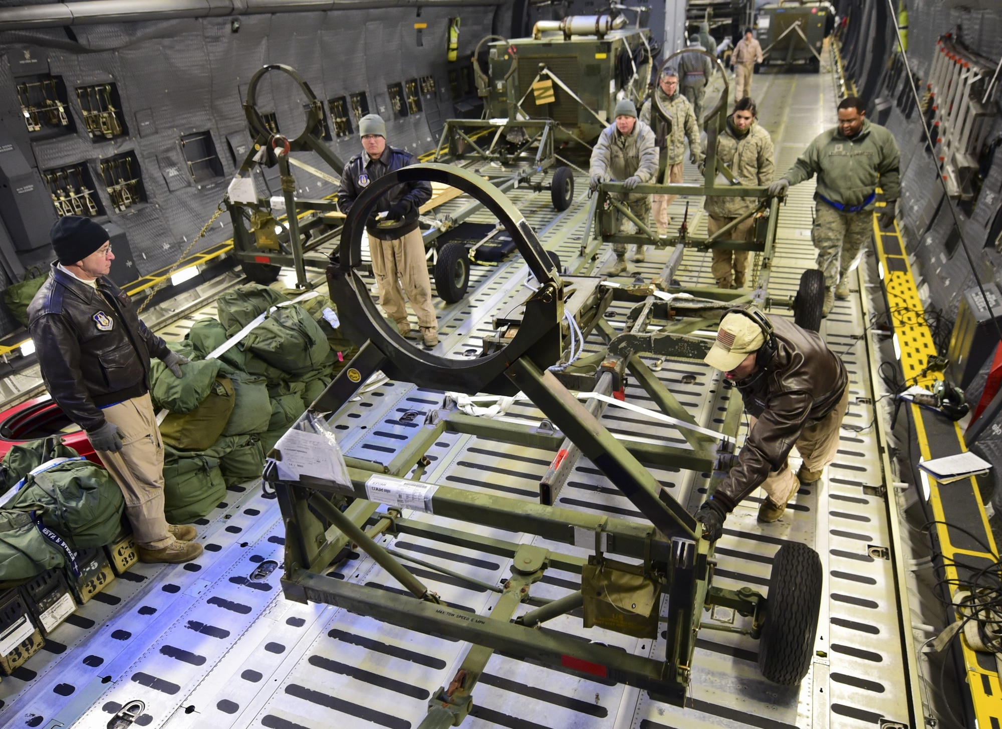 Aircrew members and Airmen from the 28th Logistics Readiness Squadron unload cargo from a C-5M Super Galaxy at Ellsworth Air Force Base, S.D., Feb. 2, 2018. Equipment used in the recent deployment to Andersen AFB, Guam, was flown back to Ellsworth AFB between Jan. 30 and Feb. 6, where it was unloaded by the 28th LRS and sent back to its respective squadrons. (U.S. Air Force photo by Senior Airman Randahl J. Jenson)