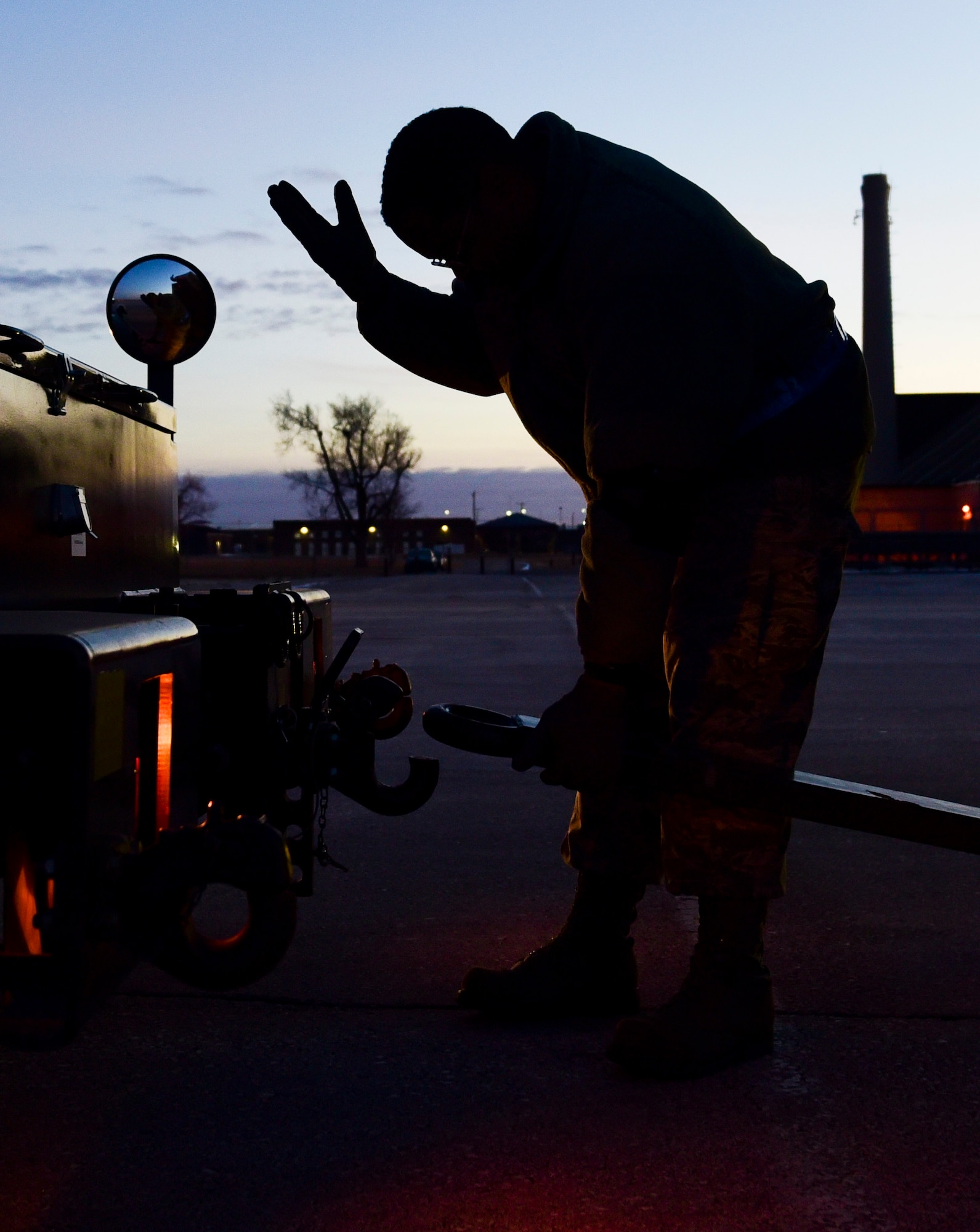 Master Sgt. Jeremie Washington, the 28th Maintenance Squadron production superintendent of aerospace ground equipment, guides a driver at Ellsworth Air Force Base, S.D., Feb. 2, 2018. Cargo returning from deployments is unloaded by the 28th Logistics Readiness Squadron and returned to its respective units. (U.S. Air Force photo by Senior Airman Randahl J. Jenson)