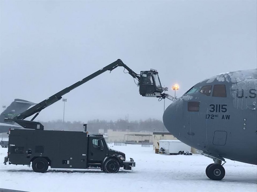 Airmen assigned to the 821st Contingency Response Group de-ice a C-17 Globemaster cargo aircraft during the Rapid Alaskan Airlift Week exercise at Eielson Air Force Base, Alaska.