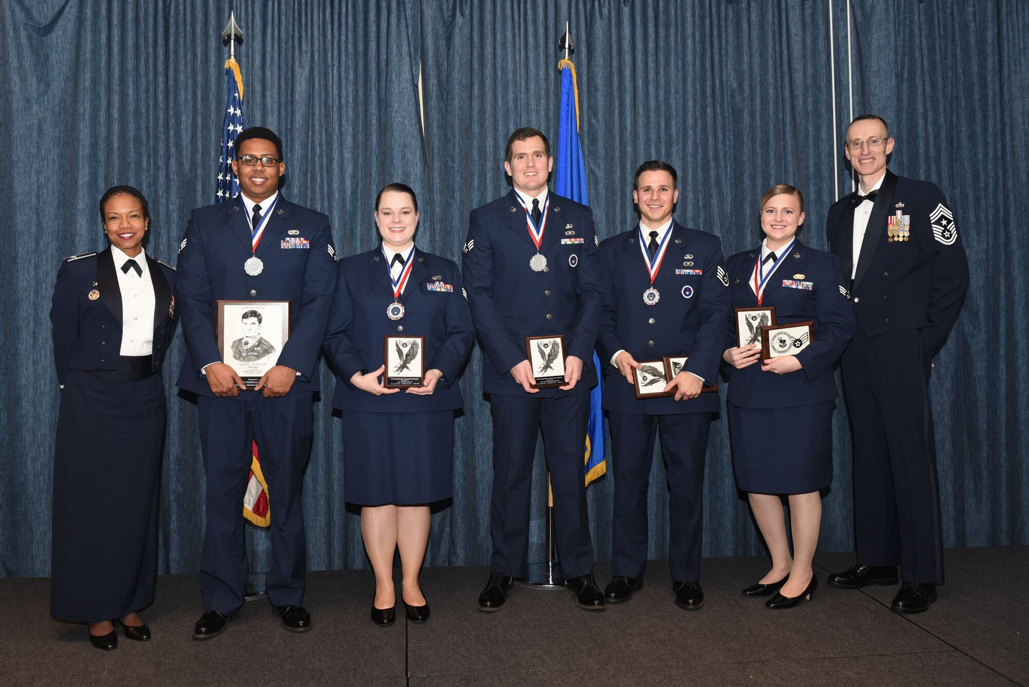 Airmen of Airman Leadership School Class 18 Bravo, who earned top honors, pose for a photo with Col. Yvonne Spencer, 92nd Mission Support Group commander, and Chief Master Sgt. Lee Mills, 92nd Air Refueling Wing command chief, Feb. 8, 2018, at Fairchild Air Force Base, Washington. ALS is a five-week course that focuses on leadership abilities, profession of arms and effective communication in the workplace. (U.S. Air Force photo/Airman 1st Class Whitney Laine)