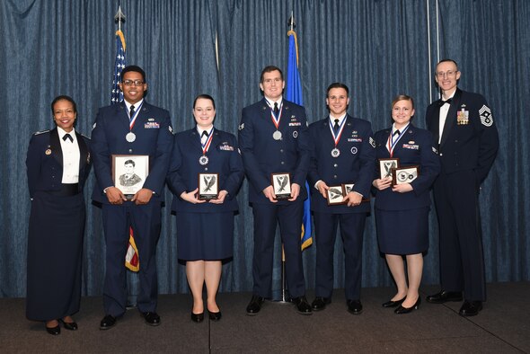 Airmen of Airman Leadership School Class 18 Bravo, who earned top honors, pose for a photo with Col. Yvonne Spencer, 92nd Mission Support Group commander, and Chief Master Sgt. Lee Mills, 92nd Air Refueling Wing command chief, Feb. 8, 2018, at Fairchild Air Force Base, Washington. ALS is a five-week course that focuses on leadership abilities, profession of arms and effective communication in the workplace. (U.S. Air Force photo/Airman 1st Class Whitney Laine)