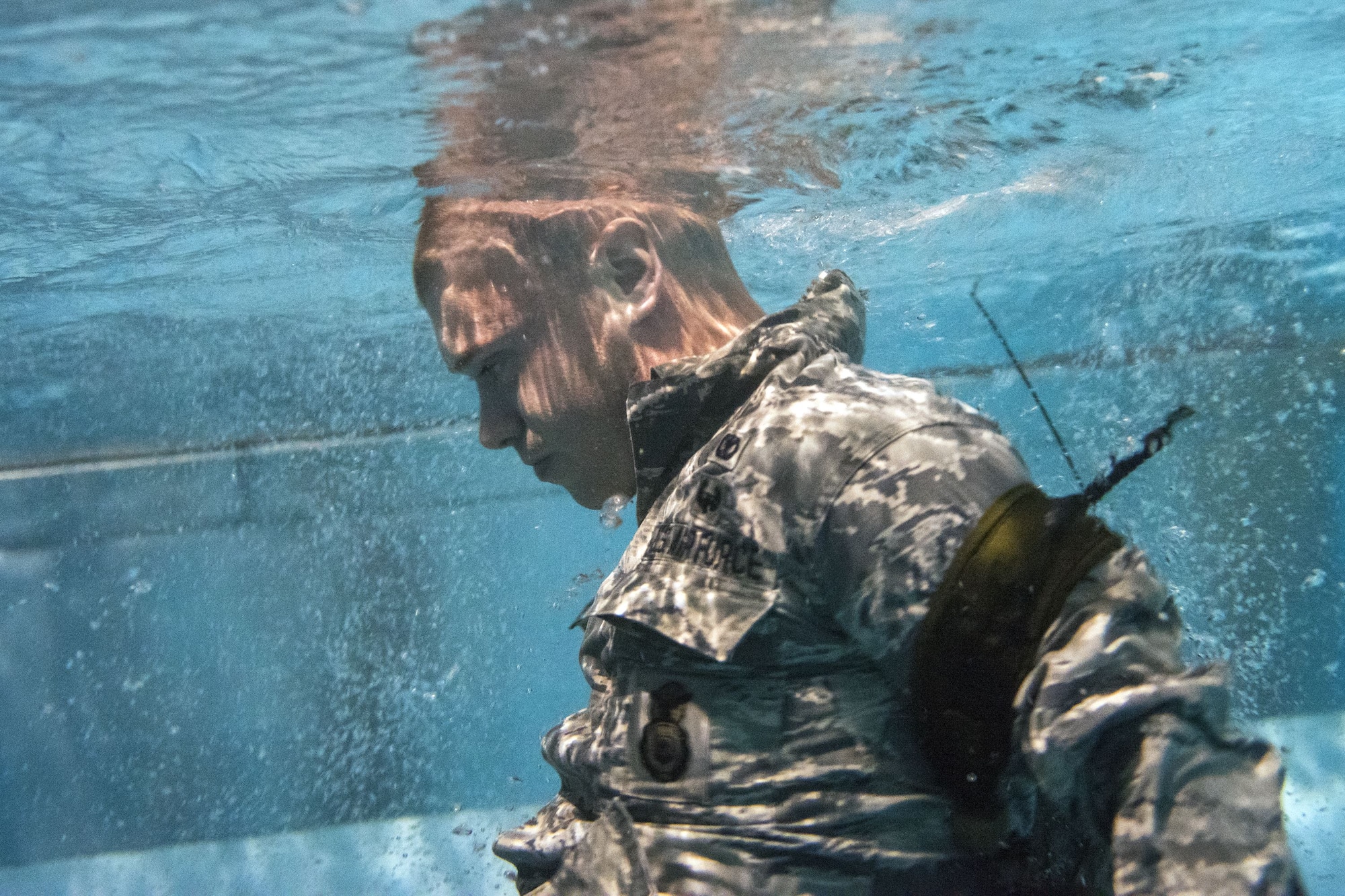 An Airman attempts to ditch his gear while underwater during a water survival assessment, Feb. 9, 2018, at Moody Air Force Base, Ga. The assessment is part of a three-day ranger assessment that’s designed to determine whether Airmen are ready to attend the Air Force pre Ranger-Assessment Course held at Fort Bliss Army post, Tx. The Ranger cadre test Airmen’s physical fitness, tactical abilities, land navigation skills, leadership qualities, water confidence and academic ability to determine if they have the knowledge and will to become Ranger qualified. (U.S. Air Force photo by Airman Eugene Oliver)