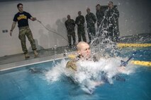 An Airman jumps into a pool during a water survival assessment, Feb. 9, 2018, at Moody Air Force Base, Ga. The assessment is part of a three-day ranger assessment that’s designed to determine whether Airmen are ready to attend the Air Force pre Ranger-Assessment Course held at Fort Bliss Army post, Texas. The Ranger cadre test Airmen’s physical fitness, tactical abilities, land navigation skills, leadership qualities, water confidence and academic ability to determine if they have the knowledge and will to become Ranger qualified. (U.S. Air Force photo by Airman Eugene Oliver)