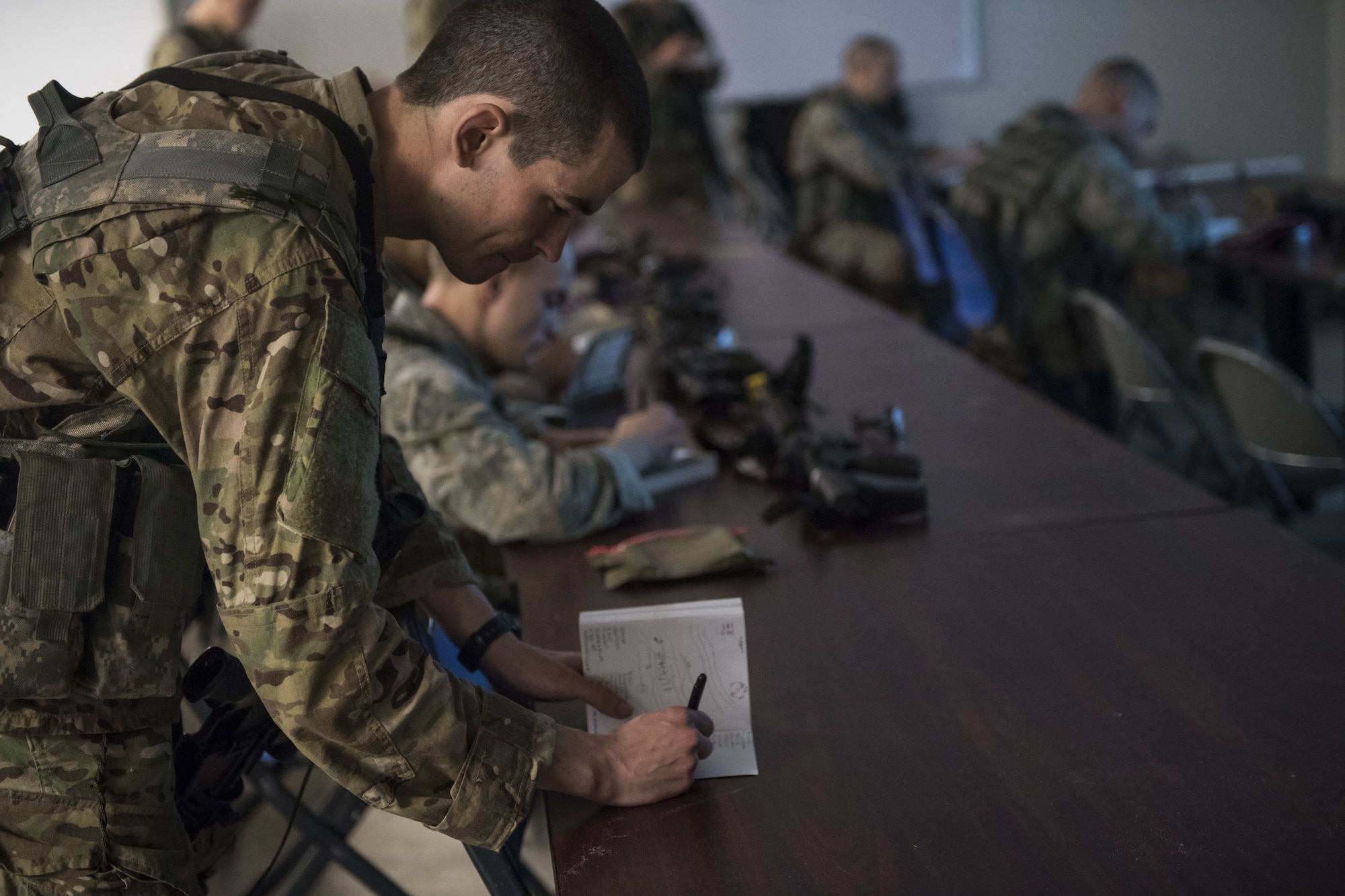 An Airman takes notes during a Pre Ranger Assessment Course, Feb. 11, 2018, at Moody Air Force Base, Ga. The three-day assessment is designed to determine whether Airmen are ready to attend the Air Force Ranger Assessment Course held at Fort Bliss Army Post, Texas. Ranger cadre test Airmen’s physical fitness, tactical abilities, land navigation skills, leadership qualities, water confidence and academic ability to determine if they have the knowledge and will to become Rangers. (U.S. Air Force photo by Senior Airman Janiqua P. Robinson)