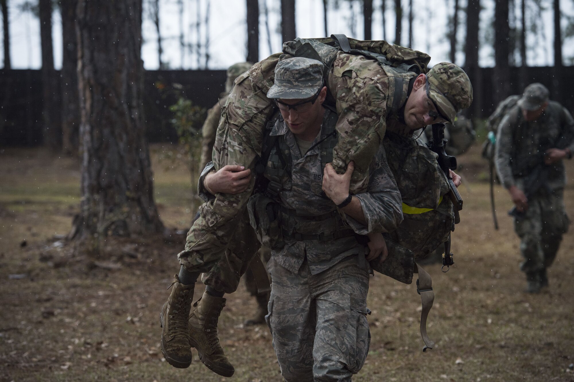 An Airman carries a simulated casualty during a Pre Ranger Assessment Course, Feb. 11, 2018, at Moody Air Force Base, Ga. The three-day assessment is designed to determine whether Airmen are ready to attend the Air Force Ranger Assessment Course held at Fort Bliss Army Post, Texas. Ranger cadre test Airmen’s physical fitness, tactical abilities, land navigation skills, leadership qualities, water confidence and academic ability to determine if they have the knowledge and will to become Rangers. (U.S. Air Force photo by Senior Airman Janiqua P. Robinson)