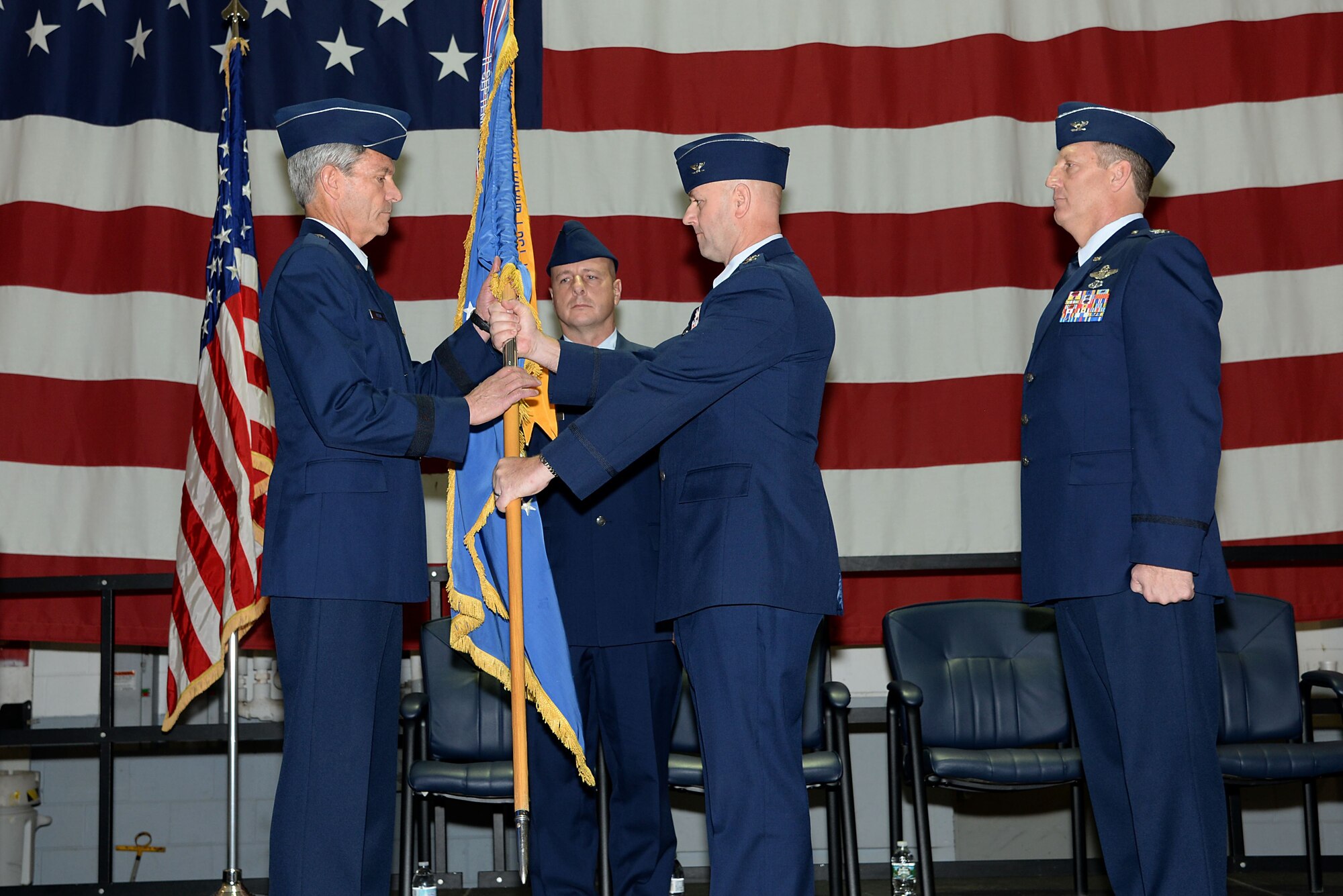 A picture of U.S. Air Force Col. John R. DiDonna, Jr., outgoing 177th Fighter Wing commander, passing the 177th FW guidon to Brig. Gen. Kevin J. Keehn, commander of the New Jersey Air National Guard.
