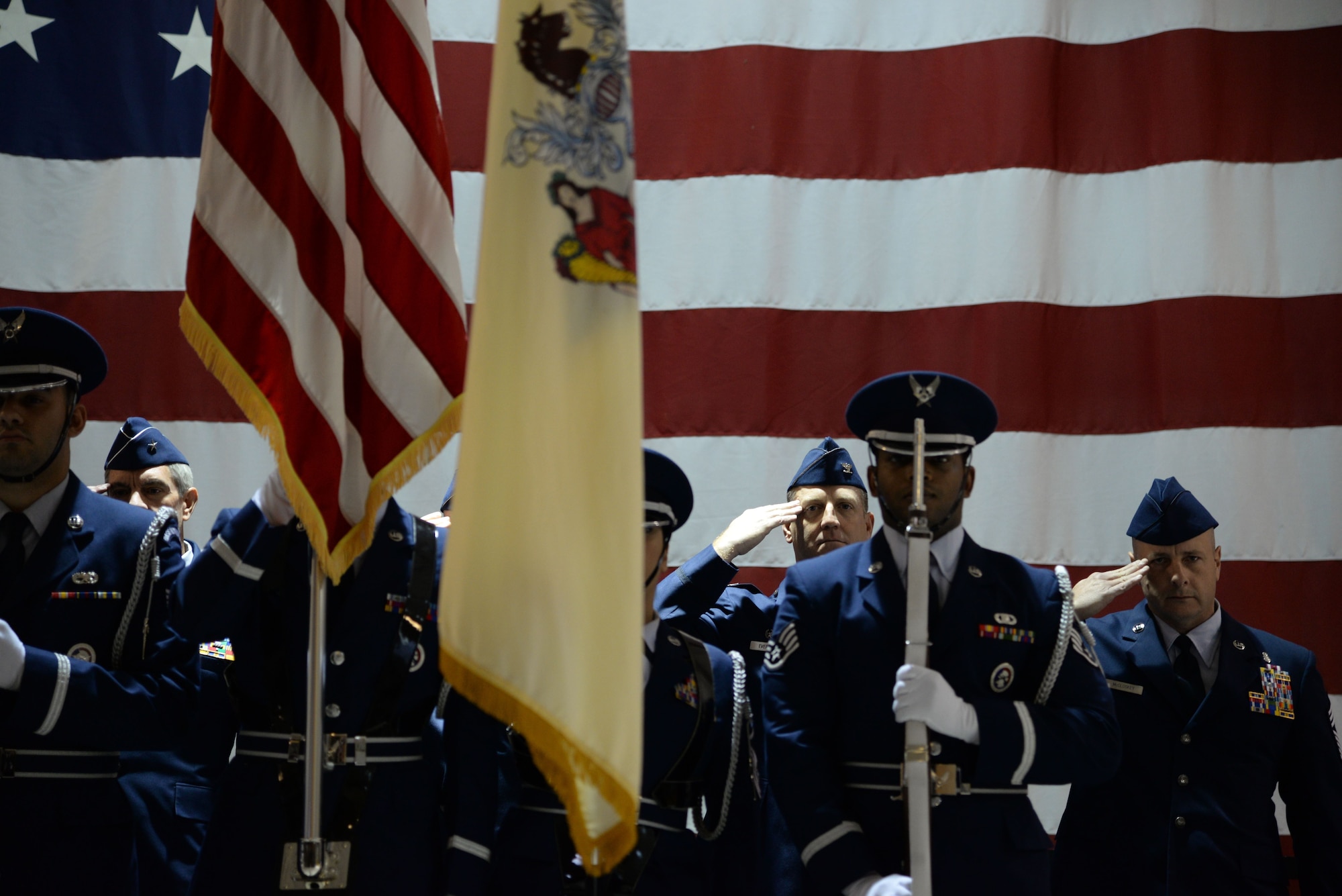 A picture of members of the New Jersey Air National Guard's 177th Fighter Wing saluting during the playing of the National Anthem during the 177th.