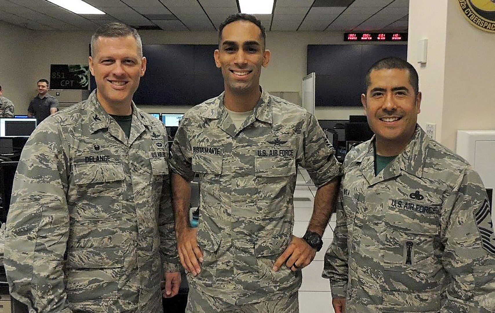 Col. Eric Delange, 688th Cyberspace Wing Commander (left), and Chief Master Sgt. Emilio Avila, 688th CW command chief (right), congratulate Master Sgt. Anthony Bustamante, 92nd Cyberspace Operations Squadron flight chief, on being selected as one of the first Airmen to undergo direct appointment into the Air Force cyberspace officer corps. Direct appointment for cyberspace officers was authorized under the 2017 National Defense Authorization Act. The candidates’ experience will be used to develop policies and procedures for future applicants. (Courtesy photo)