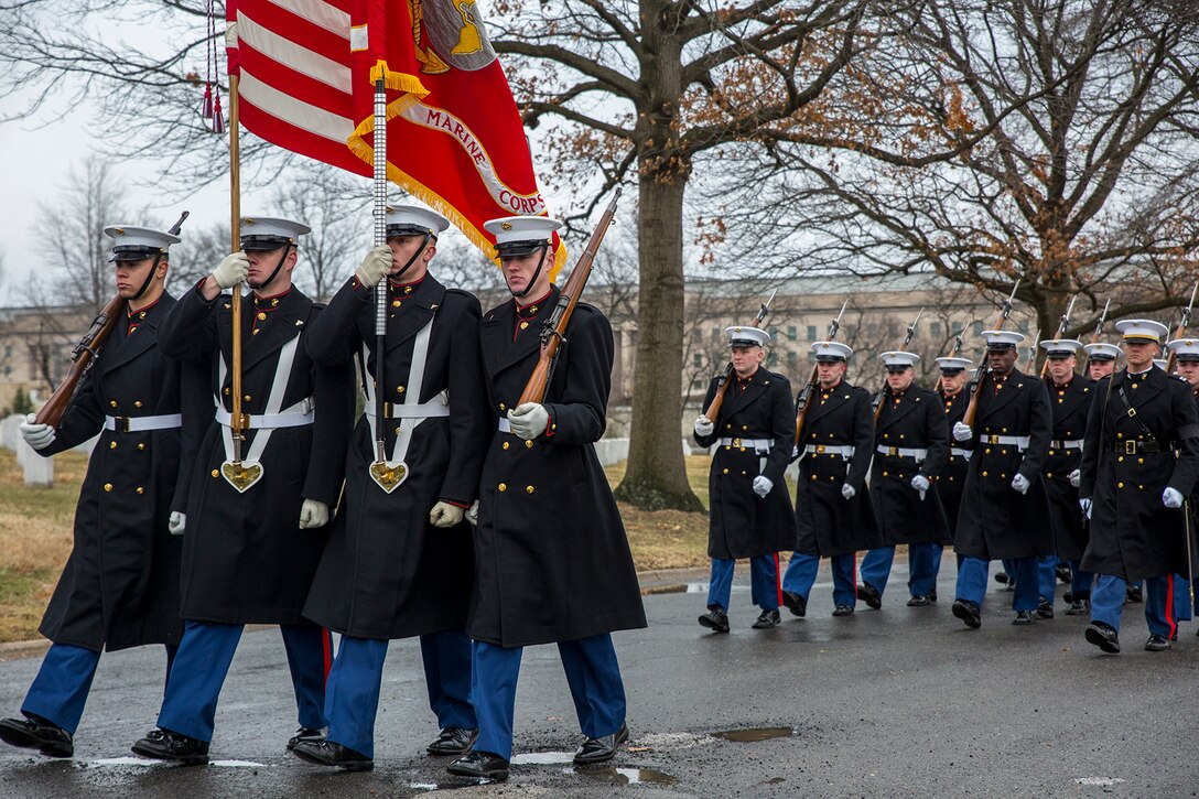 The Marine Corps Color Guard marches with the National Flag and the Marine Corps Battle Colors during a full honors funeral for Col. Travis M. Provost at Arlington National Cemetery, Arlington, Va., Feb. 12, 2018. Provost joined the U.S. Marine Corps on November 10, 1989 and was commissioned as a 2nd Lieutenant in April 1990. He deployed six times, supporting multiple operations including Operation Iraqi Freedom in 2005 and retired in April 2014 after a distinguished and decorated career. (Official U.S. Marine Corps photo by Sgt. Robert Knapp/Released)